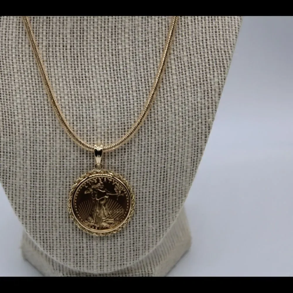New 22k gold American Eagle 1/2 ounce coin mounted in 14k gold coin bezel